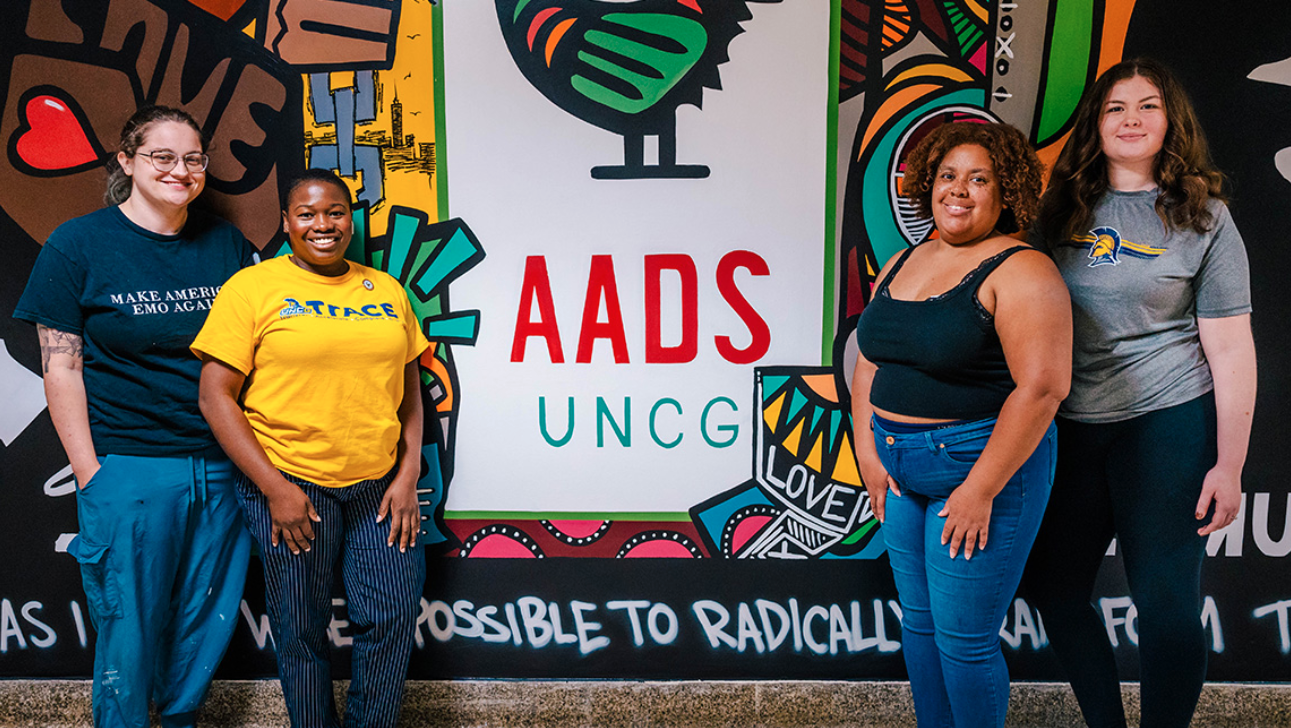UNCG AADS students stand in front of the mural